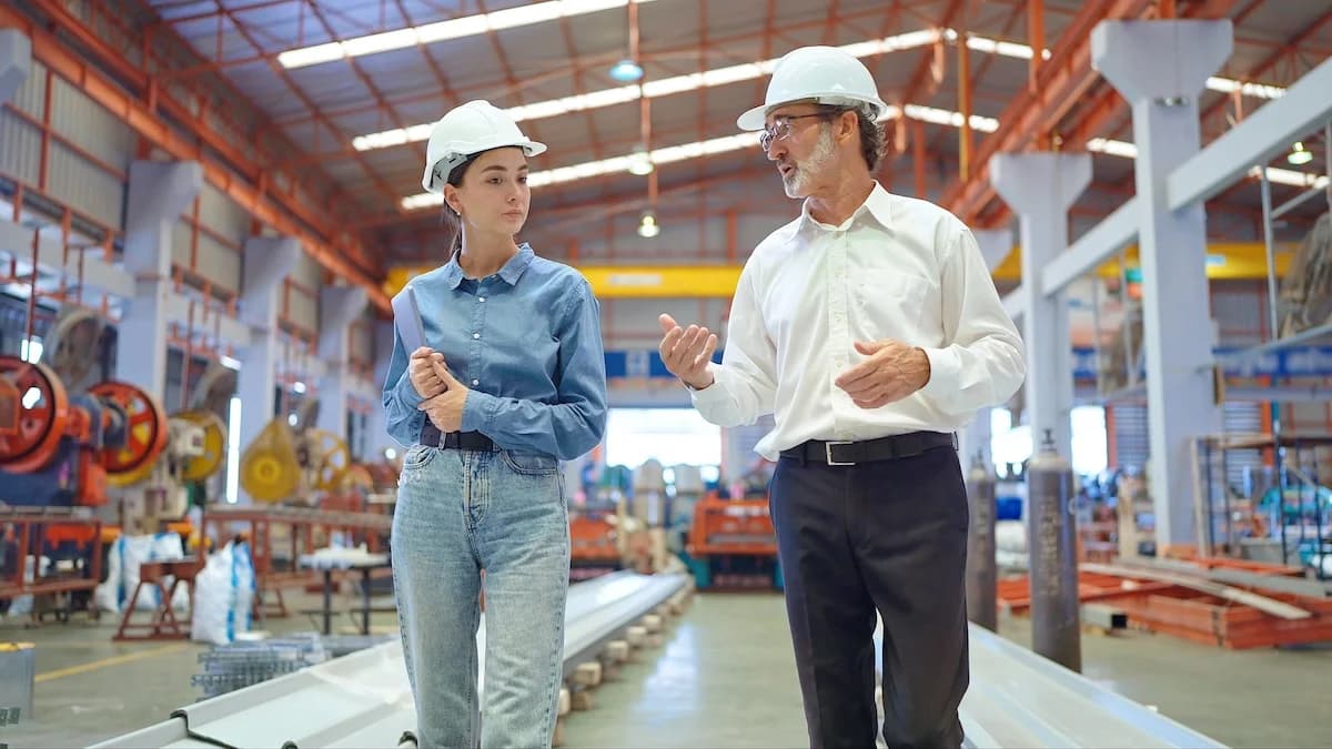 Business owners walking through a manufacturing facility